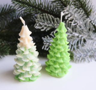 New Year's decorative handmade candles made of natural soy wax in the form of a Christmas tree and a tangerine